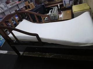 Old antique toddler bed with mattress