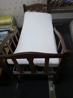 Old antique toddler bed with mattress