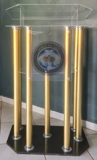 6-legged Podium With Golden Tubes And A Black Wooden Base