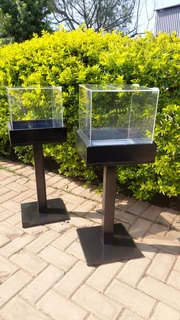 Clear Offering Boxes On Wooden Stands