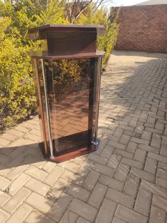 A Warm Wooden Podium With Smoked Acrylic To Round It Off