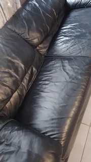 Gerald Yosh Black leather long seater couch (sears up to 4)