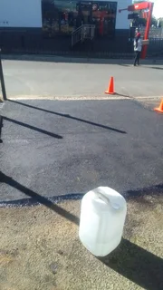 Tar surfacing and brick paving