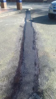 Tar surfacing and brick paving