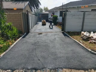 Tar surfacing and brick paving