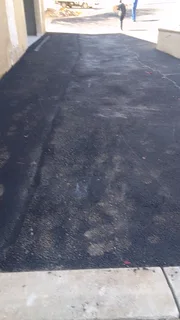 Tar surfacing and brick paving