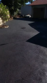 Tar surfacing and brick paving