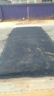 Tar surfacing and brick paving