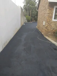 Tar surfacing and brick paving