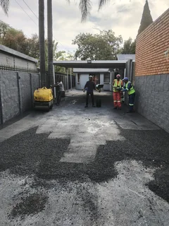 Tar surfacing and brick paving