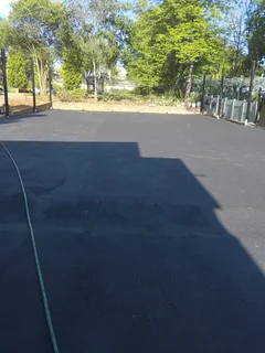 Tar surfacing and brick paving