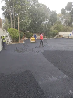 Tar surfacing and brick paving