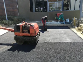 Tar surfacing and brick paving