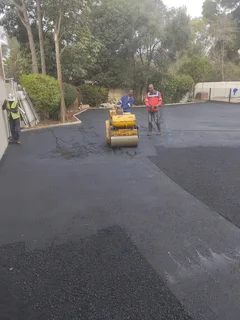 Tar surfacing and brick paving