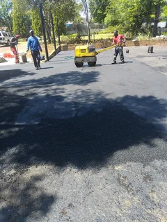 Tar surfacing and brick paving
