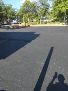 Tar surfacing and brick paving