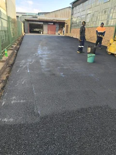 Tar surfacing and brick paving
