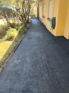 Tar surfacing and brick paving