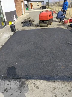 Tar surfacing and brick paving