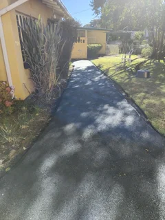 Tar surfacing and brick paving