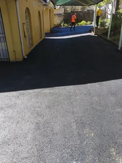 Tar surfacing and brick paving