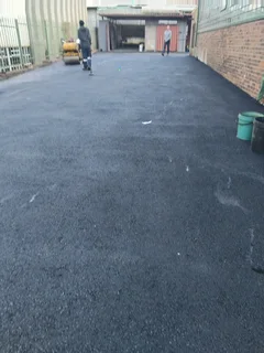 Tar surfacing and brick paving