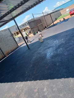 Tar surfacing and brick paving