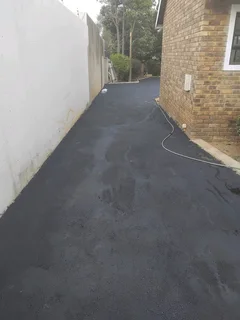Tar surfacing and brick paving