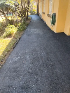 Tar surfacing and brick paving