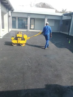 Tar surfacing and brick paving