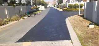 Tar surfacing and brick paving