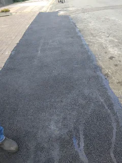 Tar surfacing and brick paving