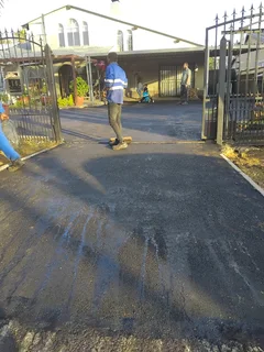 Tar surfacing and brick paving