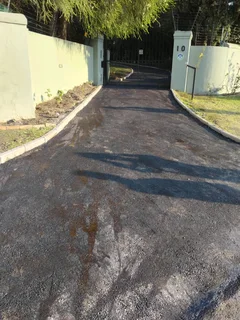 Tar surfacing and brick paving