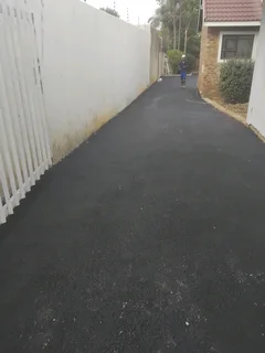 Tar surfacing and brick paving