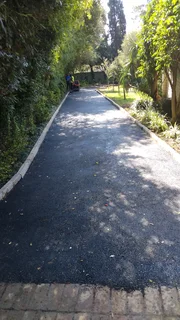 Tar surfacing and brick paving