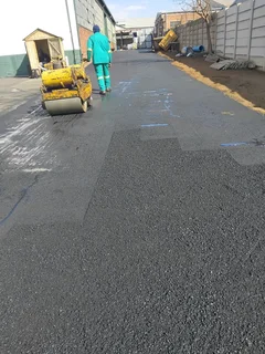 Tar surfacing and brick paving