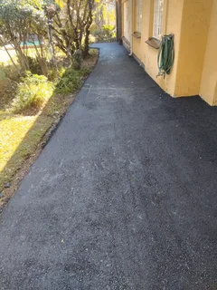Tar surfacing and brick paving