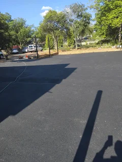 Tar surfacing and brick paving