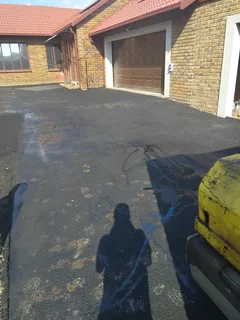 Tar surfacing and brick paving