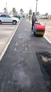 Tar surfacing and brick paving