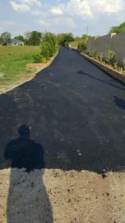 Tar surfacing and brick paving
