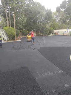 Tar surfacing and brick paving