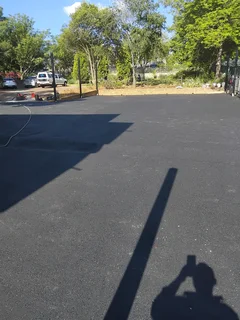 Tar surfacing and brick paving