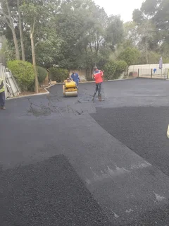 Tar surfacing and brick paving