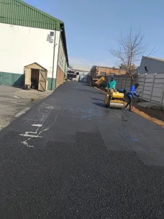 Tar surfacing and brick paving