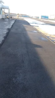 Tar surfacing and brick paving