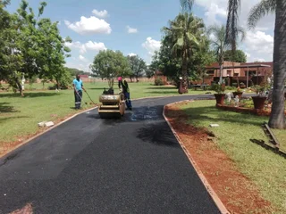 Tar surfacing and brick paving