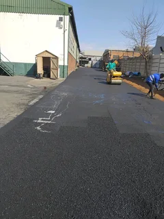 Tar surfacing and brick paving