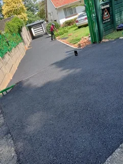 Tar surfacing and brick paving